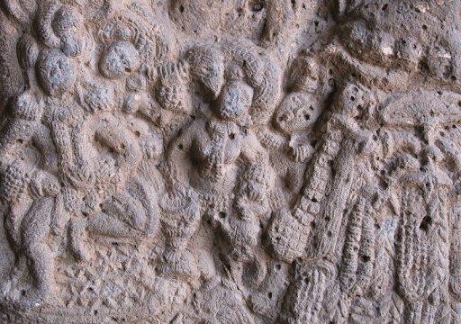 A relief shows a woman playing Tabla